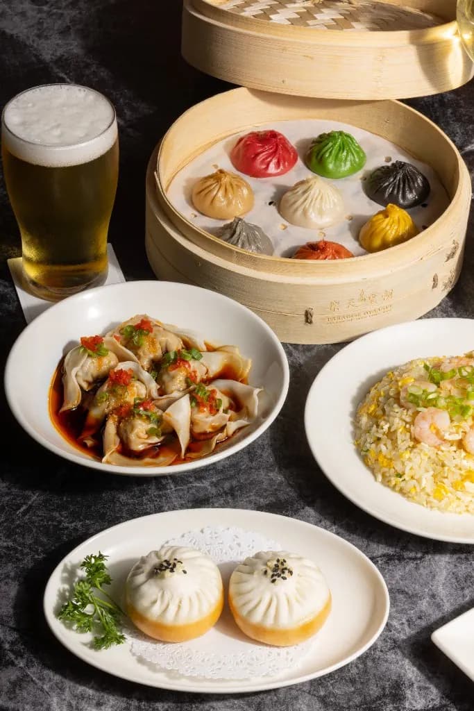 Happy hour plates with eight-flavour xiao long bao and a beer